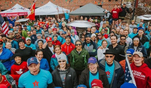 A crowd of WWP community partners pose for a photo outside.