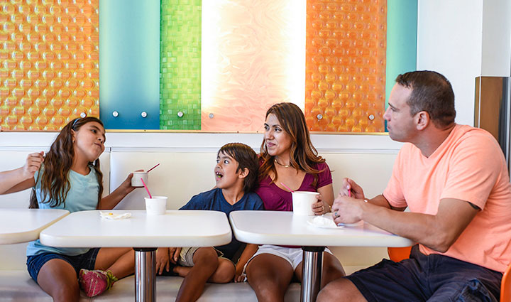 Wounded warrior Bill Geiger sits at a booth with his wife and two kids, eating frozen yogurt.