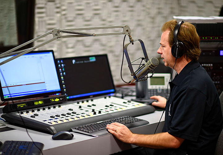 Wounded warrior Bill Jones edits audio for a radio show. 