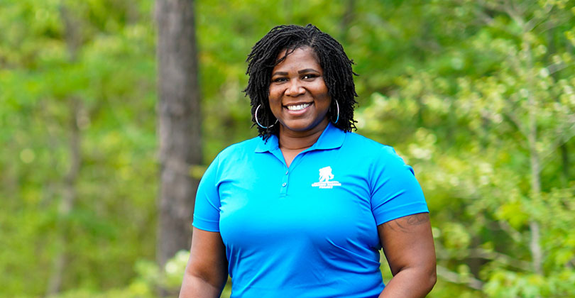 Wounded warrior Taniki Richard standing outside and smiling.