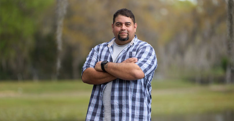 Wounded warrior Tim Aponte standing outside.