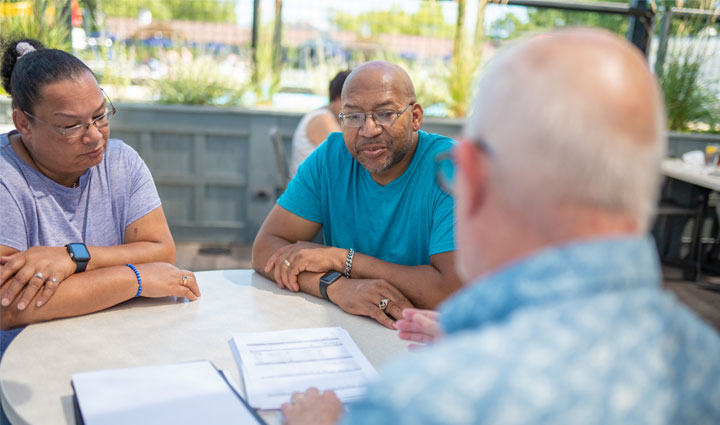 Wounded Warrior Richard Daniel and his wife Mina meeting with their financial planner.